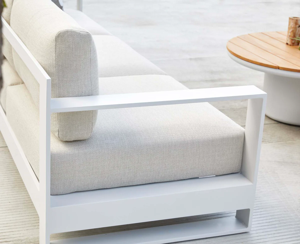 White curved outdoor sofa with soft seat and back cushions