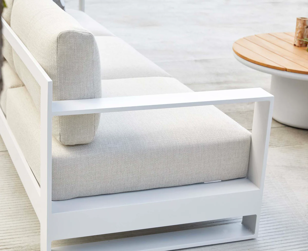 White curved outdoor sofa with soft seat and back cushions