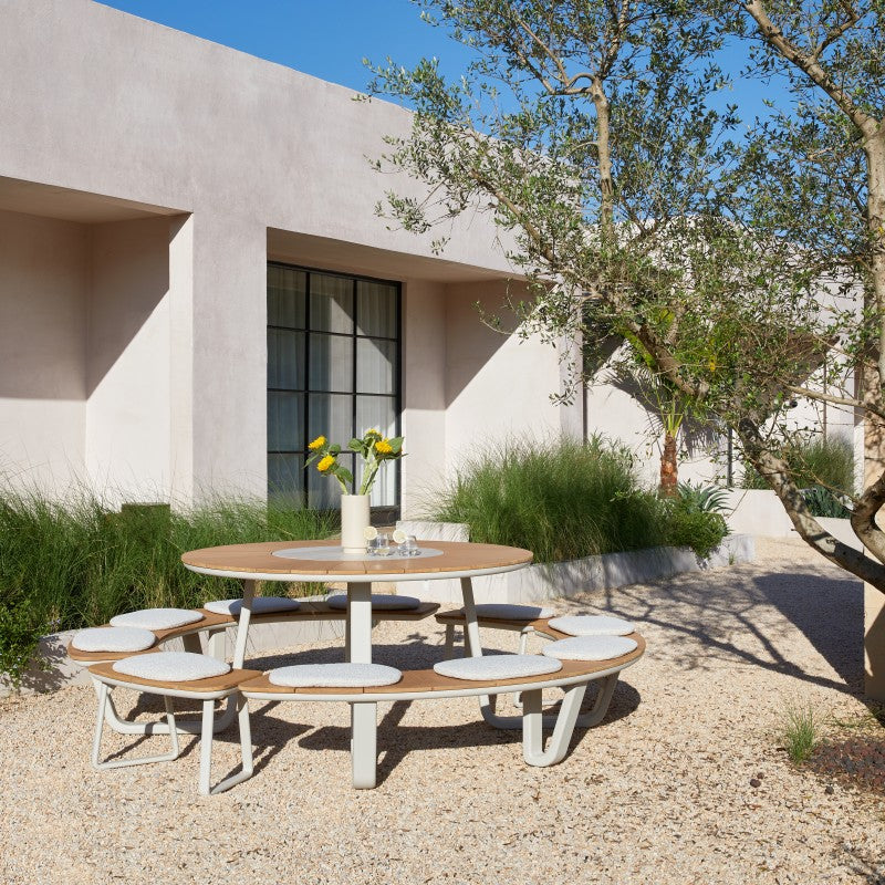 ALMA round outdoor dining set styled beside a swimming pool