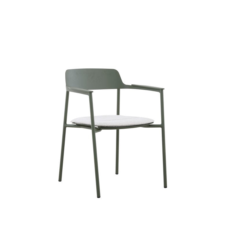 Styled angled view of the AURORA dark green outdoor dining armchair with light cushion