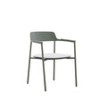 Styled angled view of the AURORA dark green outdoor dining armchair with light cushion