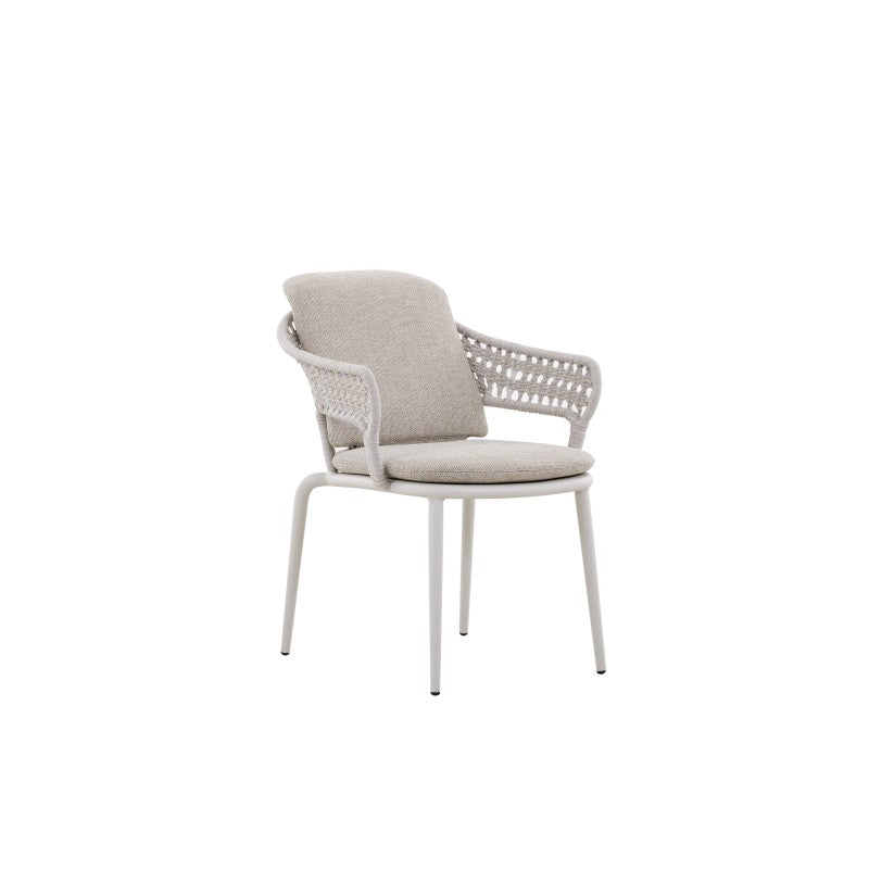 Angled view of the BOSSA white woven outdoor dining armchair with light cushions