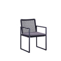 Angled view of the SUNRISE black rope-woven outdoor dining armchair with light cushion