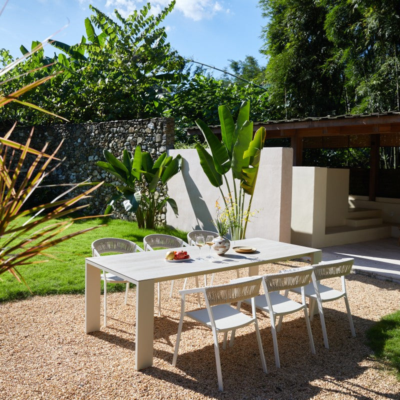 Angled view of the SUNRISE 8-seater white outdoor dining table