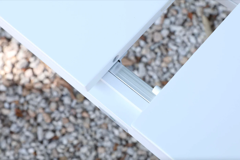 Detail of the extension mechanism on the white outdoor dining table