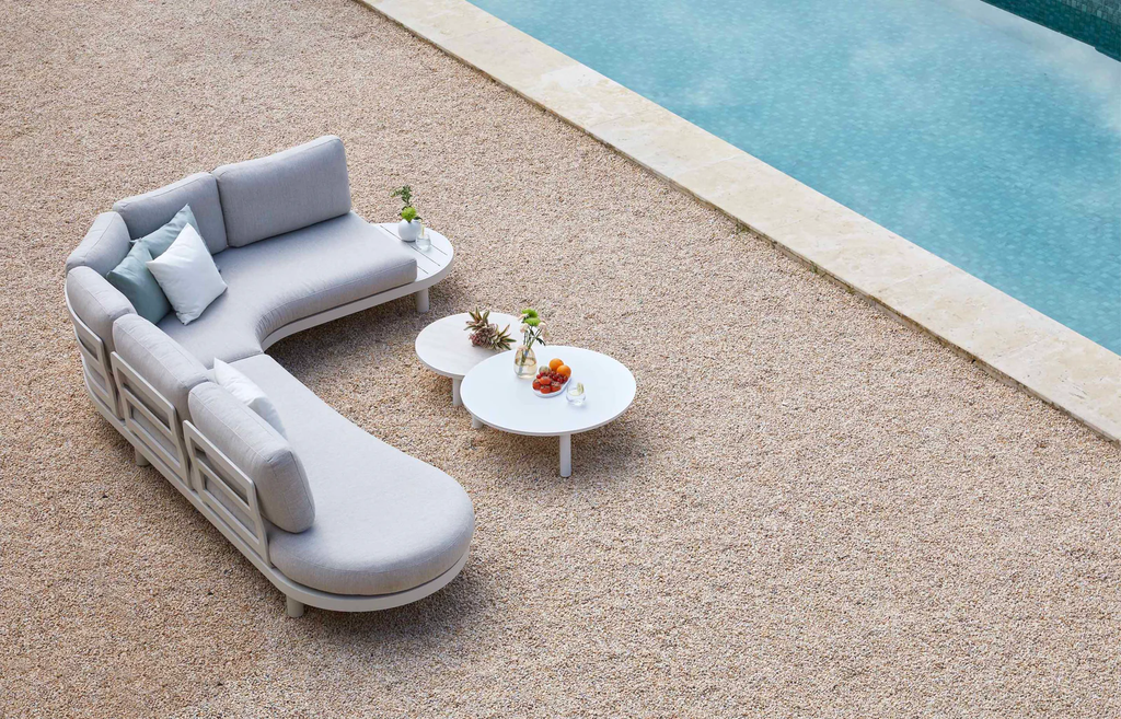 Close view of the white modular outdoor sofa and round coffee table