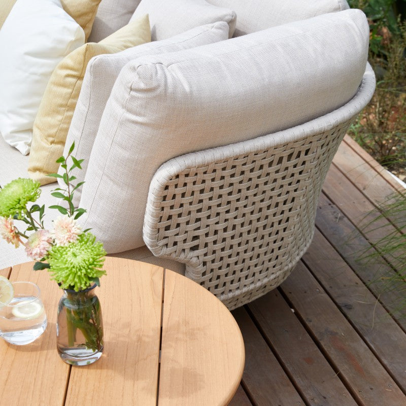 Close-up of the ALMA round outdoor daybed woven rope arm and cushions