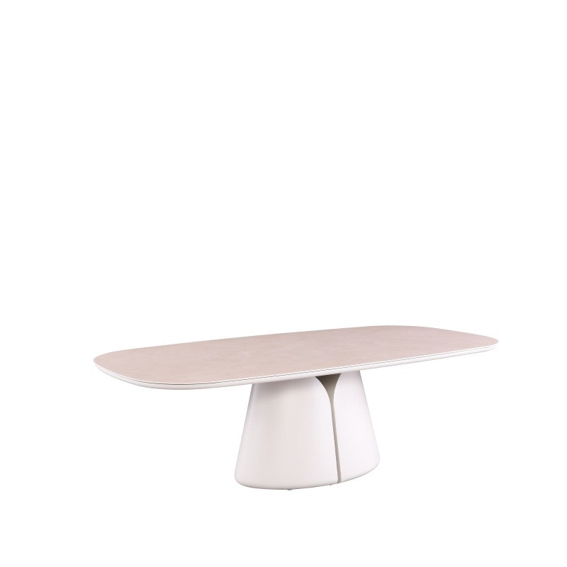 Angled view of the ALMA oval outdoor dining table with softly rounded tabletop