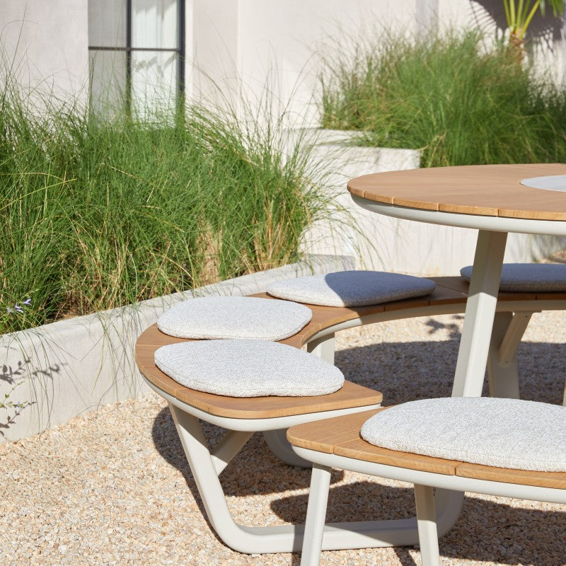 ALMA round outdoor dining set styled in a garden setting