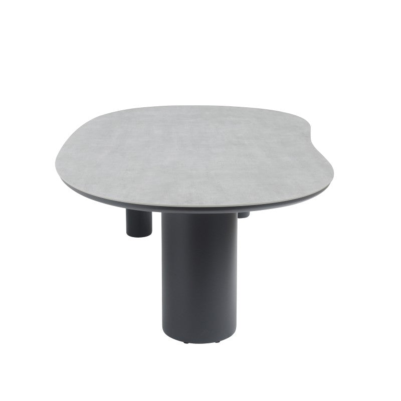 Angled view of the AMICO outdoor table with a softly curved tabletop