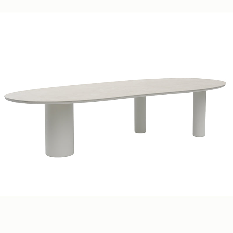 Long view of the AMICO outdoor table in a light finish with cylindrical legs