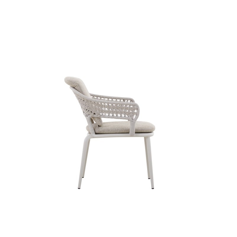 Side view of the BOSSA white woven outdoor dining armchair with light cushions