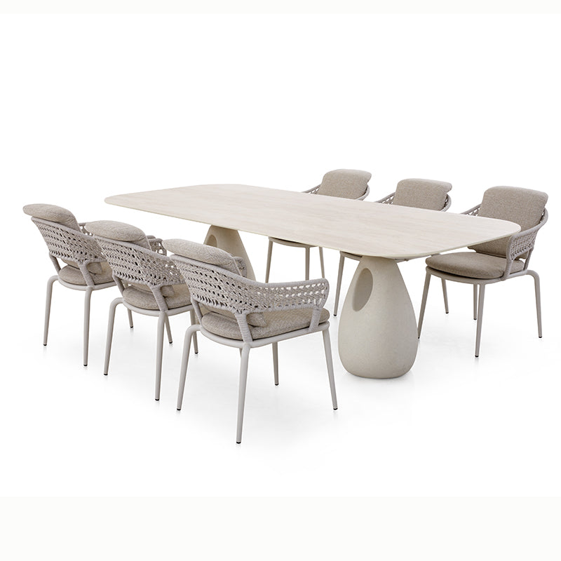 Front view of the BOSSA outdoor dining set with rounded rectangular table and woven-back chairs