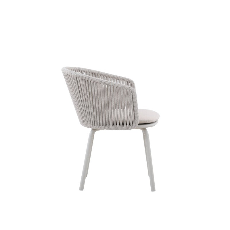 Side view of the LA TOUR white rope-woven outdoor dining armchair with light cushion