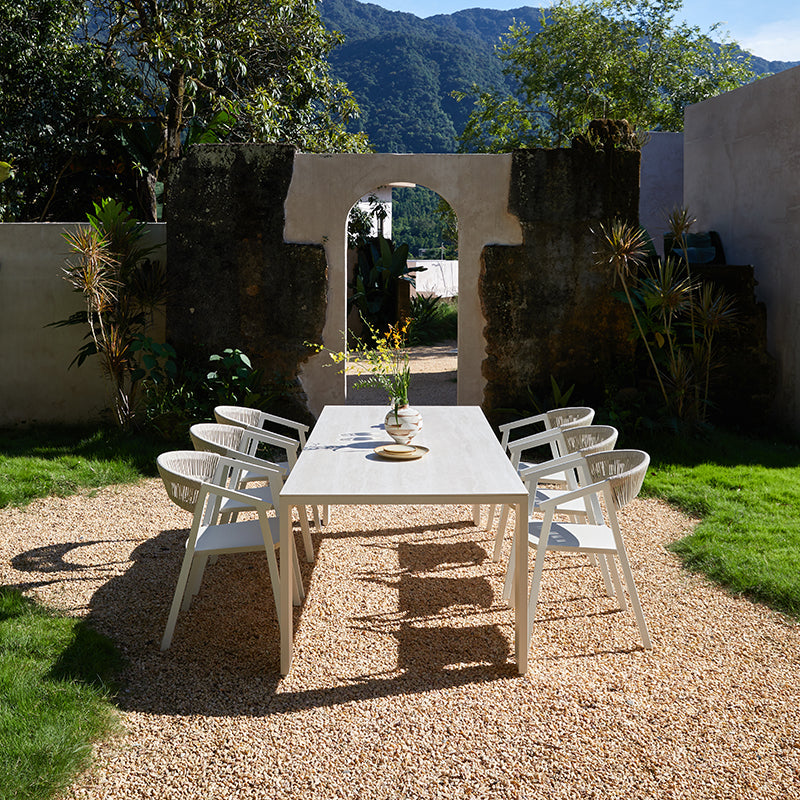 SUNRISE 8-seater white outdoor dining table styled with outdoor dining chairs