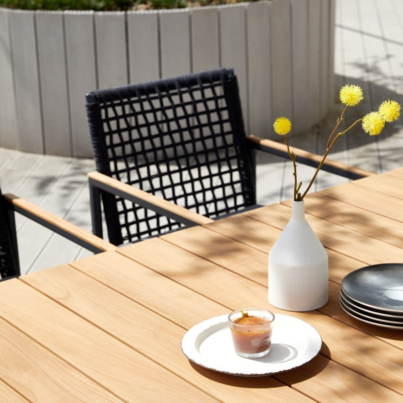 Close-up of the SUNRISE teak slatted dining tabletop and dark frame