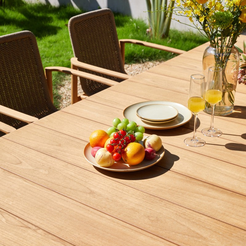 Close-up of a SUNRISE outdoor dining armchair with woven back and cushion